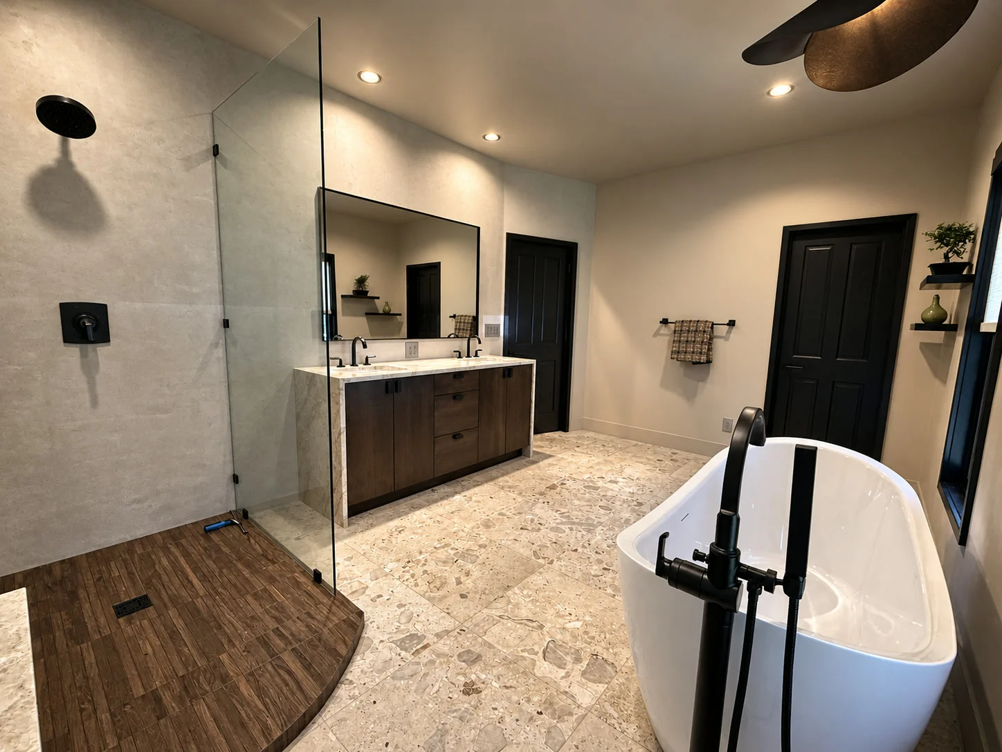 Luxury bathroom renovation with curved wood-look shower and soaking tub