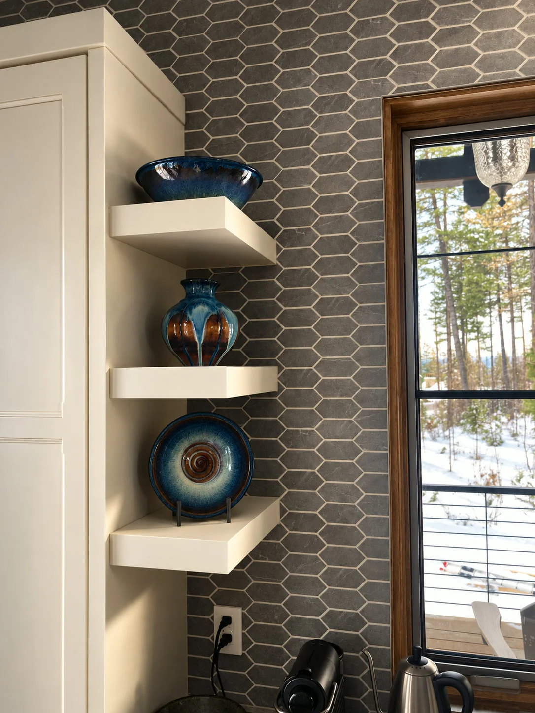 Kitchen pantry corner with grey picket mosaic tile backsplash and floating shelves