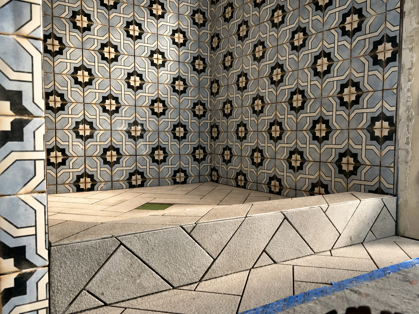 Custom shower bench and pan with Spanish-style patterned tile walls
