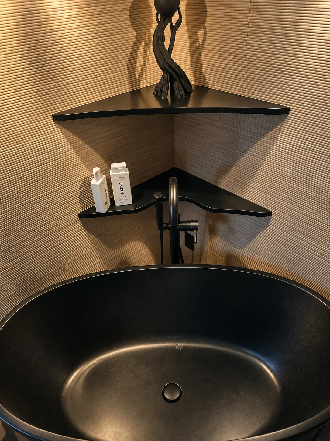 Modern powder room vanity with black vessel sink and textured wall tile
