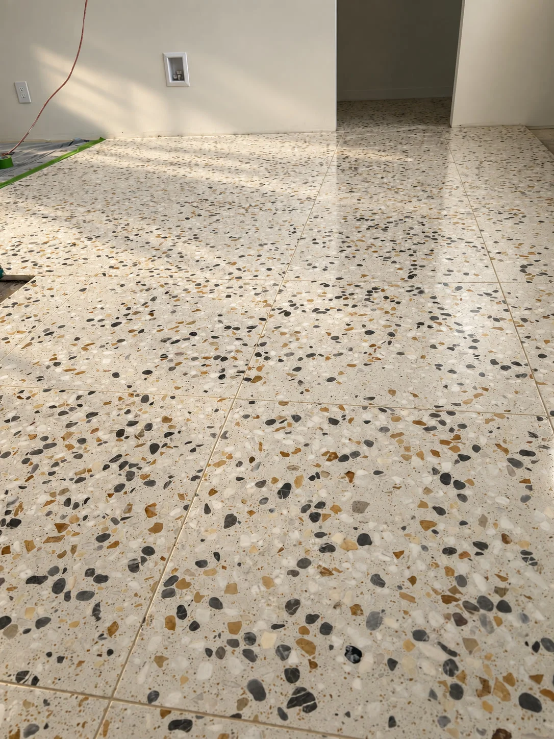 Polished terrazzo pebble floor with natural gloss finish in sunlit room